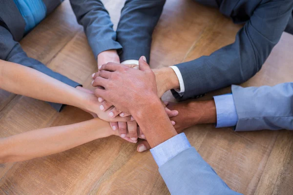 Business people joining hands in a circle