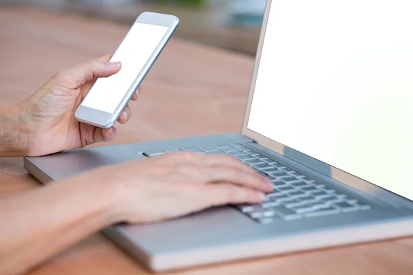 Close up view of hands typing on laptop