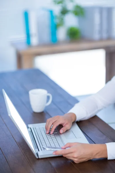 Close up view of a businessman typing on laptop