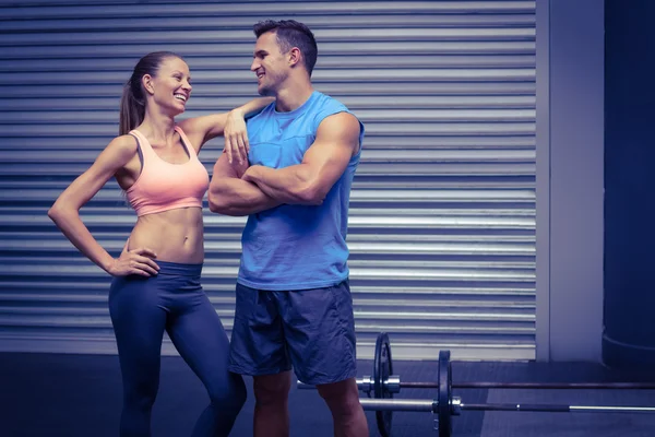 Smiling muscular couple discussing together