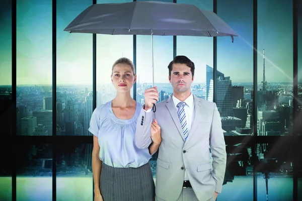 Business people holding a black umbrella