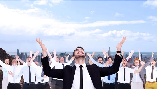 Businessman cheering with hands raised