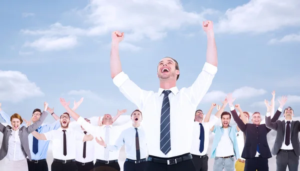 Businessman cheering with arms up