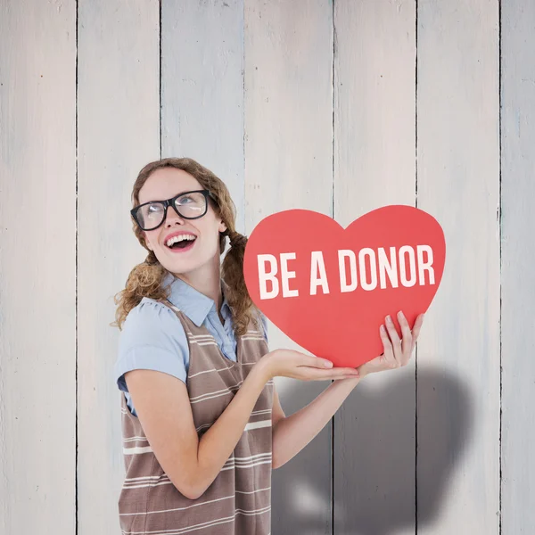 Woman holding heart card