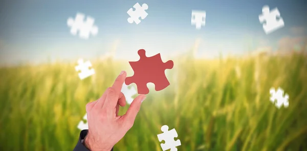 Businessman measuring jigsaw piece