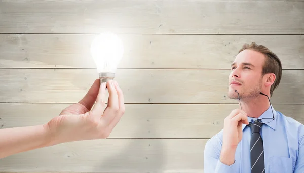 Light bulb and businessman thinking