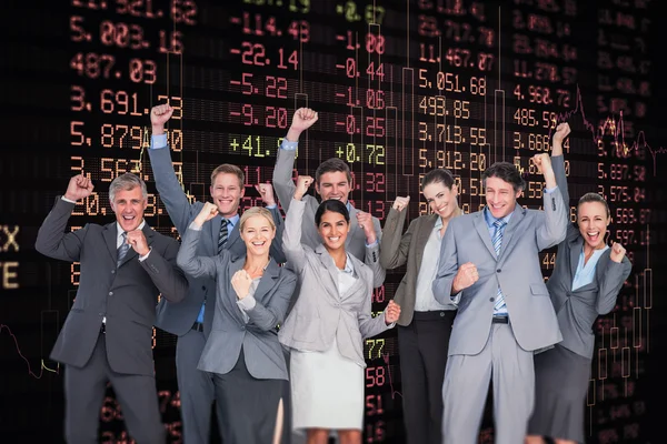 Excited business team against stocks and shares
