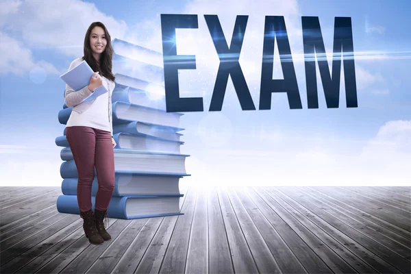 Word exam and student holding textbook