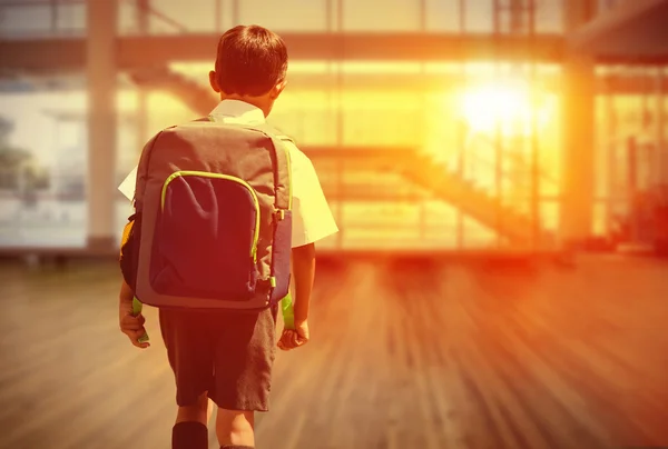 Cute pupil walking to the school bus