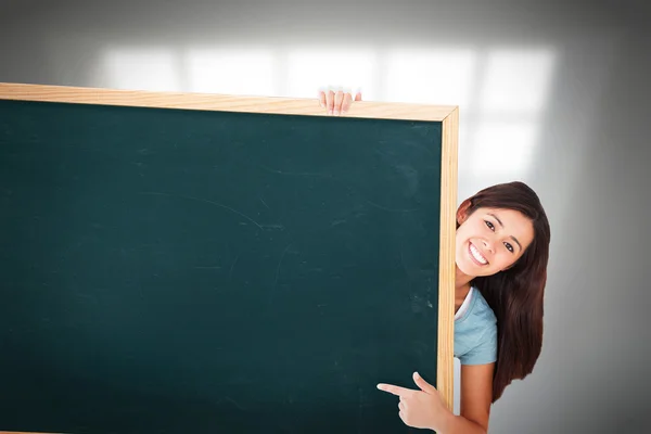 Woman pointing at a board