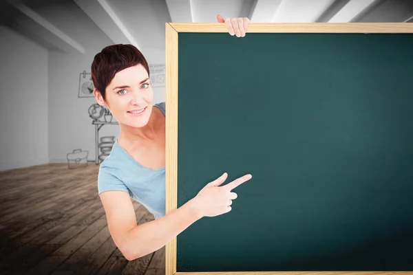 Brunette pointing at a blank panel