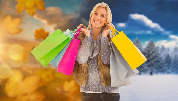 Blonde in winter clothes holding shopping bag