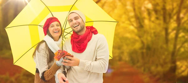 Autumn couple holding umbrella