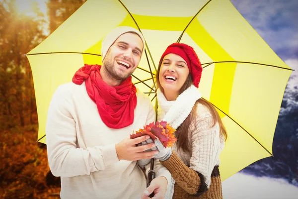 Autumn couple holding umbrella