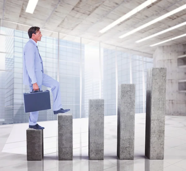 Businessman with briefcase walking over white