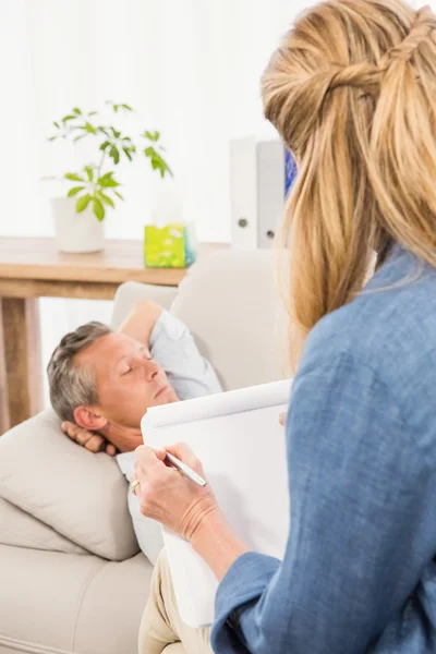 Therapist listening to male patient
