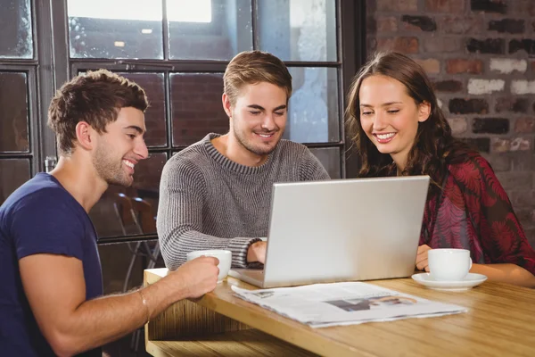 Smiling friends having coffee