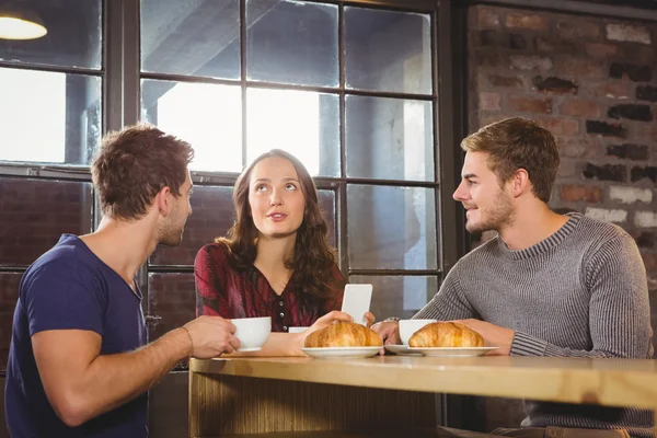 Friends talking and enjoying coffee