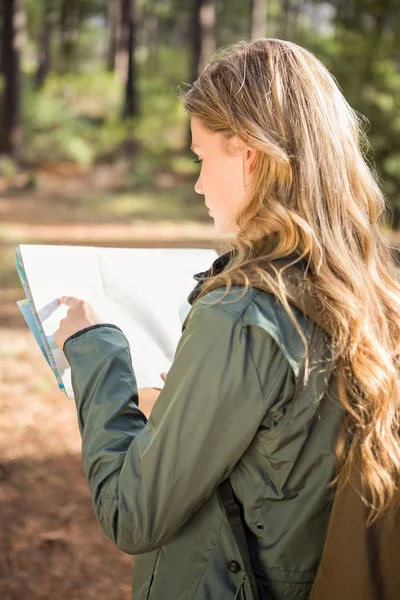 Blonde hiker reading map