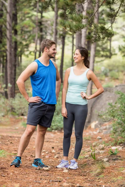 Happy joggers looking at each other