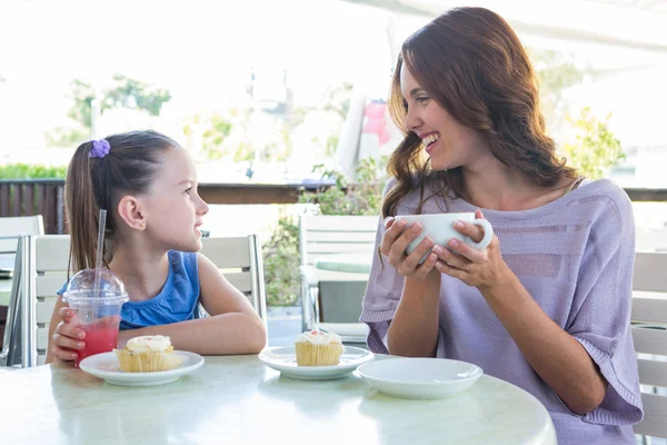 Mother and daughter enjoying cakes