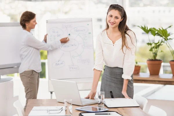 Smiling businesswomen preparing meeting