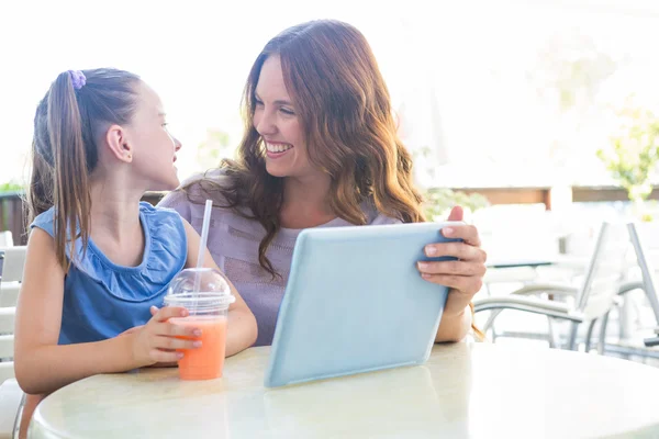 Mother and daughter using tablet