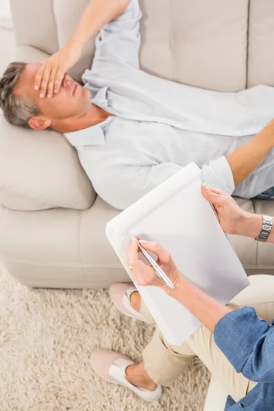 Depressed man lying on couch
