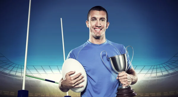 Rugby player holding trophy