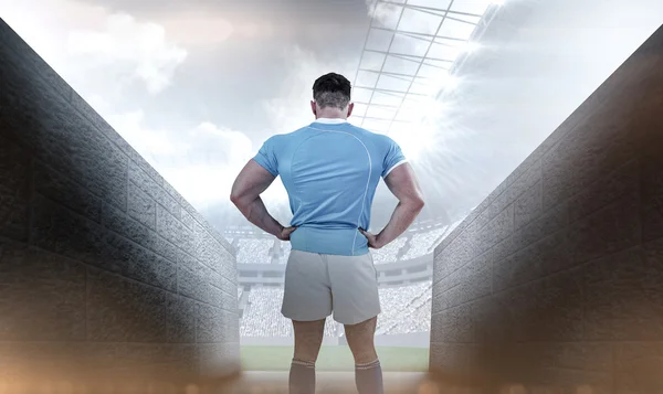 Rugby player with hands on hips