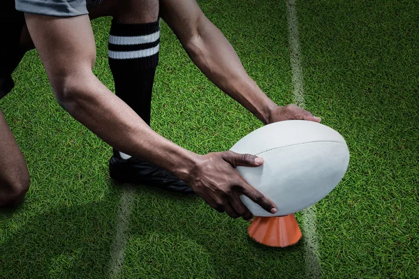 Sportsman keeping rugby ball