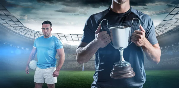 Rugby player holding trophy