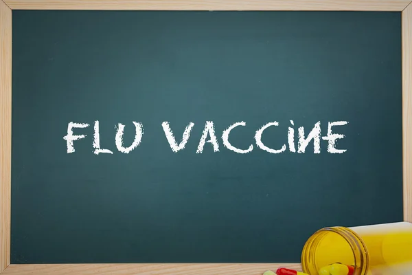 The words flu vaccine and chalkboard