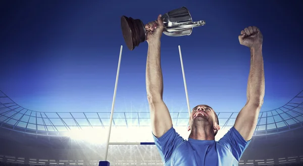 Rugby player holding trophy