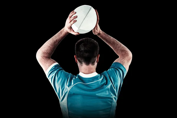 Rugby player about to throw ball