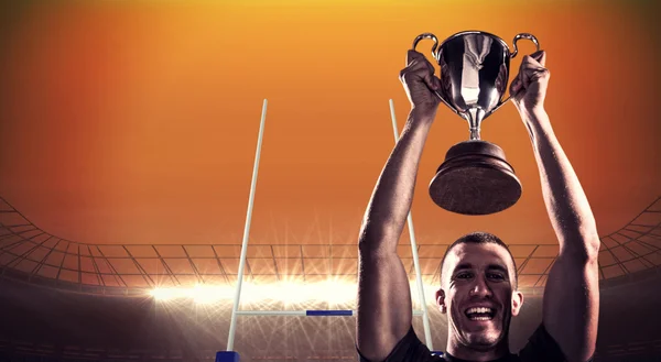 Rugby player holding trophy