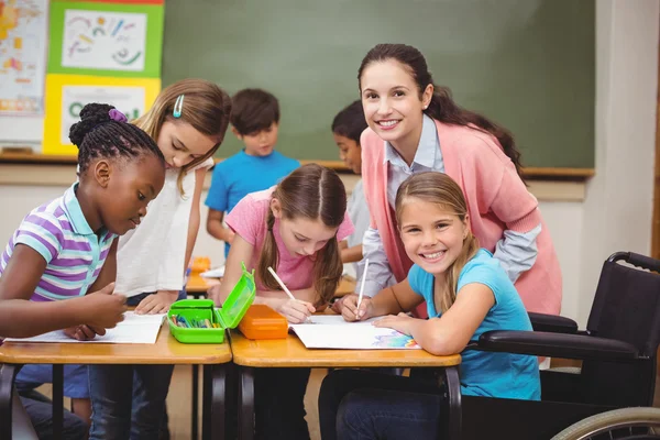 Disabled pupil smiling in classroom