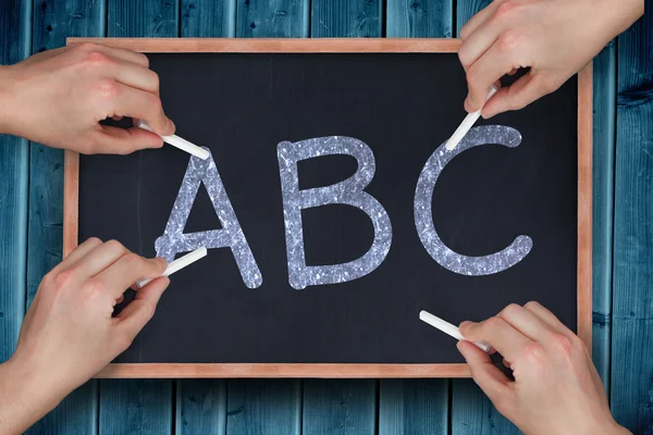 Multiple hands writing with chalk