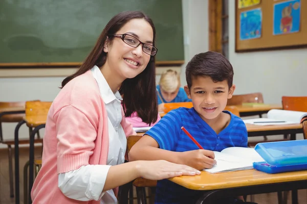 Happy teacher helping her students