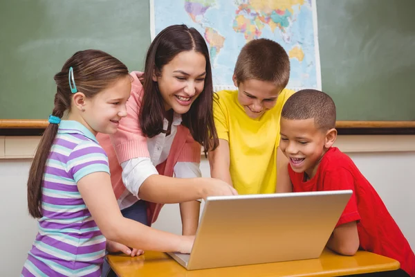 Students and teacher using a laptop