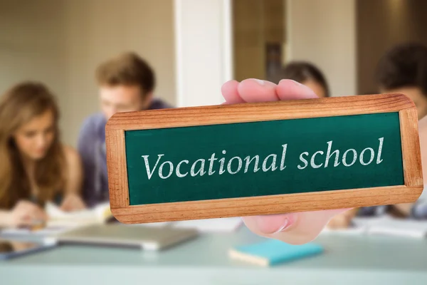 Word vocational school and hand showing chalkboard