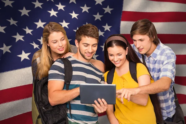 Composite image of students using digital tablet at college corridor