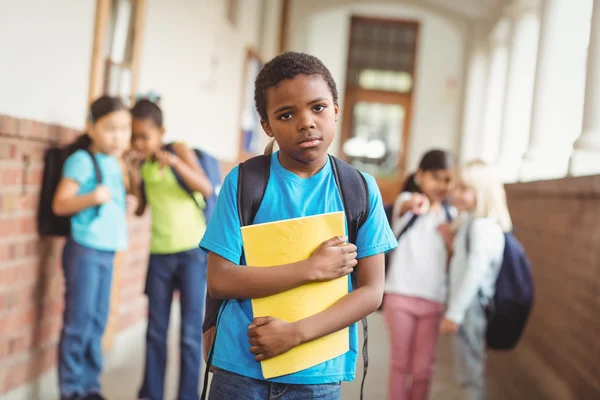 Sad pupil being bullied by classmates