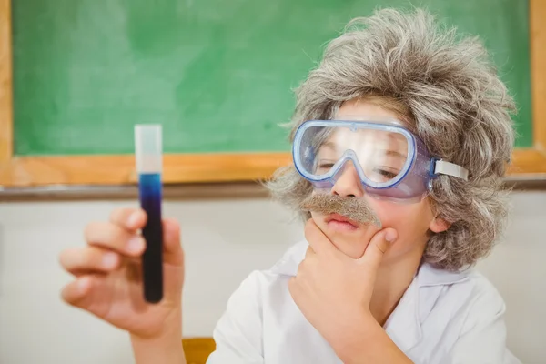Student dressed up as einstein holding vial