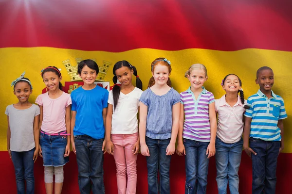 Cute pupils against spanish national flag
