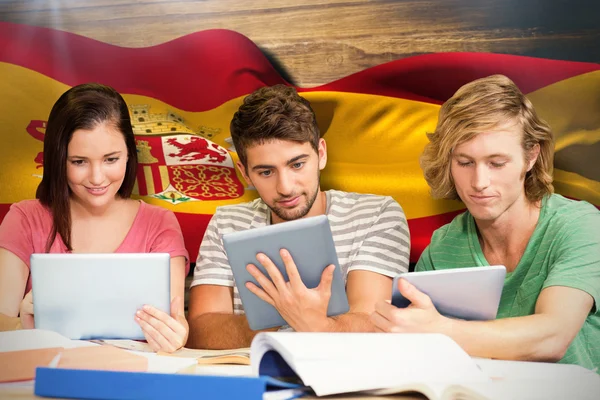 Students using digital tablets in library