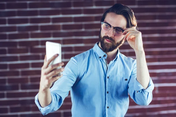 Handsome man taking picture of himself