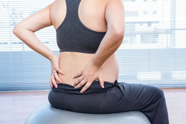 Pregnant woman exercising on exercise ball