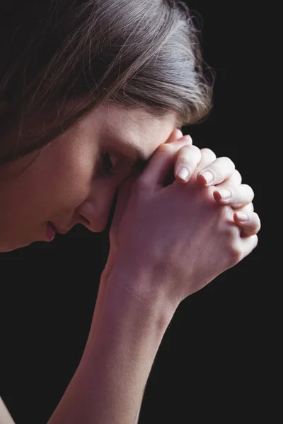 Woman praying with hands together