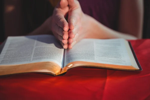 Woman praying  with her bible